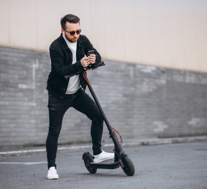 handsome-man-riding-town-scooter_1303-21275